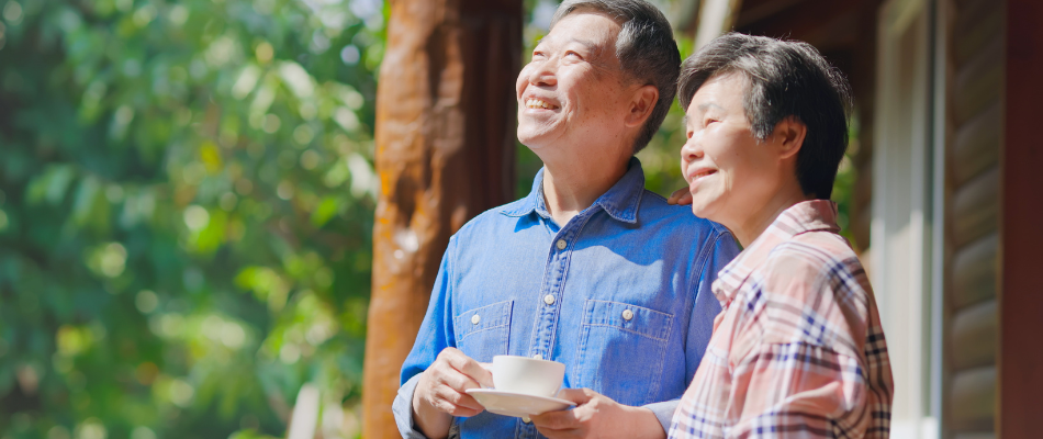 Older couple smiling and drinking coffee